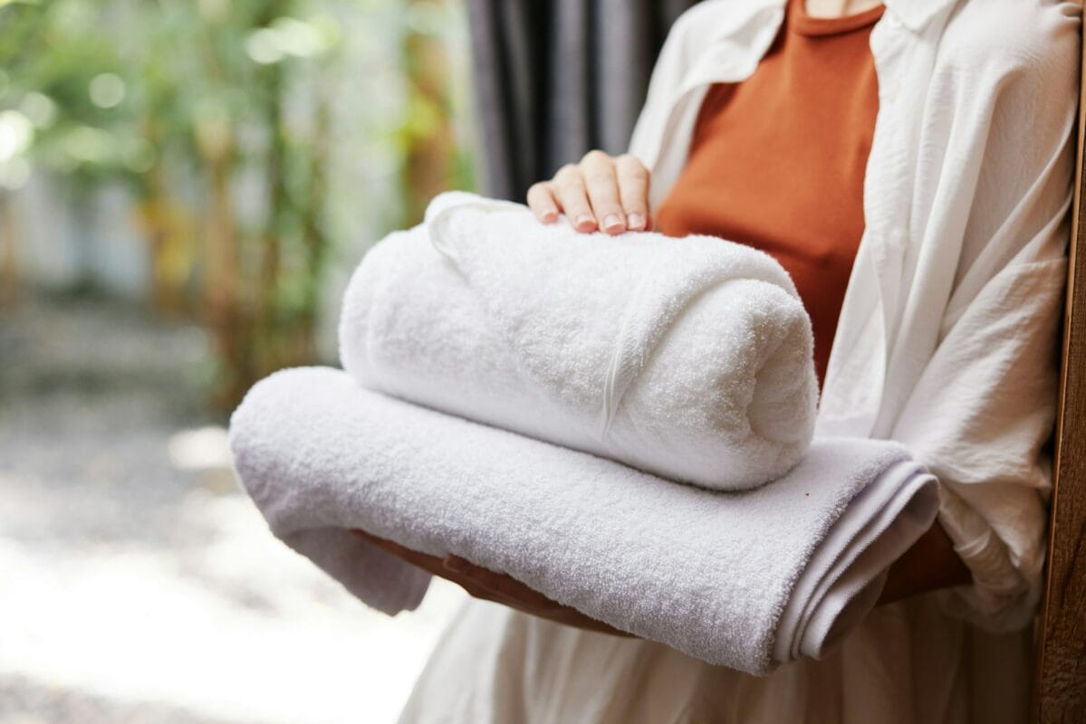 Woman towel closeup laundry stacked person service holding clean female hotel